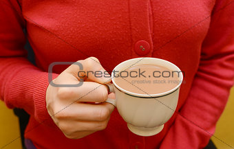 Cup of tea in a woman's hand