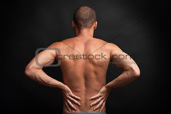 strong man holding his back with hands