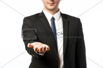 Businessman holds out his hand
