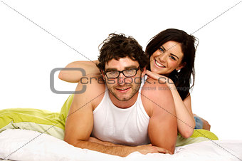 Beautiful couple in bed smiling at the camera