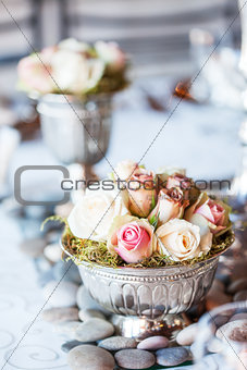 Small bouquet of roses on table at wedding