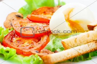 Light breakfast with soft egg, tomato and croutons