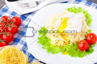 Delicious spaghetti with tomato and poached egg