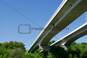 Pair of highway bridges on sky and forest