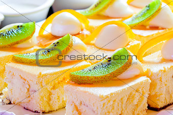 Cottage cheese pie decorated with a slice of kiwi and orange zest