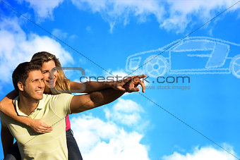 Couple pointing to clouds shaped like a car.