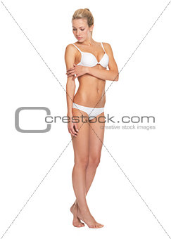 Full length portrait of confident young woman in lingerie