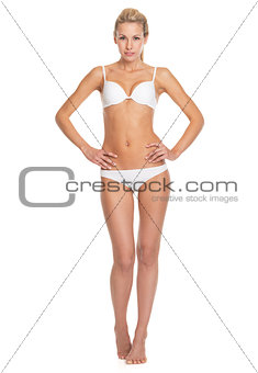 Full length portrait of happy young woman in lingerie