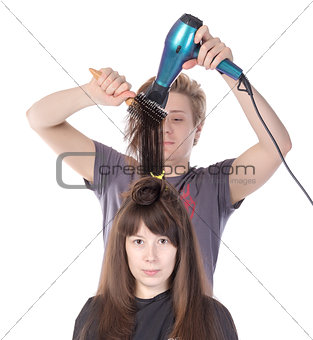 Woman enjoying having her hair blow dried