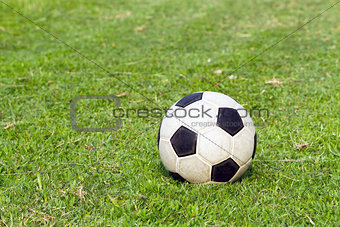 football (soccer) on green field
