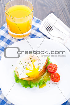 Poached egg with dill on bread