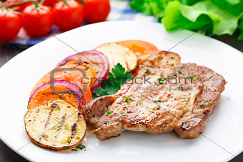 Steak with grilled vegetables on a plate