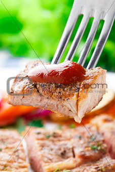 Piece of steak on fork