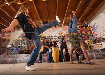 Capoeira Performers Kicking
