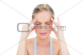 Worried fresh blonde woman having headache