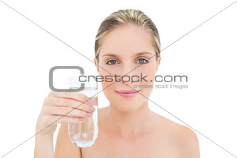 Beautiful fresh blonde woman holding a glass of water