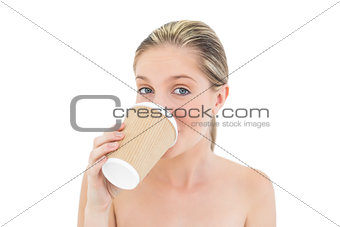 Playful fresh blonde woman drinking coffee