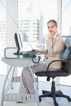 Thoughful blonde businesswoman posing