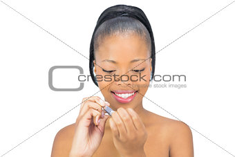 Cheerful woman using nail clipper