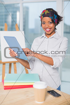 Smiling artist using tablet