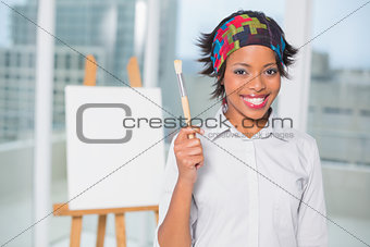 Smiling artist showing her brush