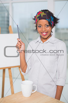 Smiling artist holding a pen