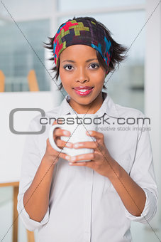 Artistic woman holding cup of coffee