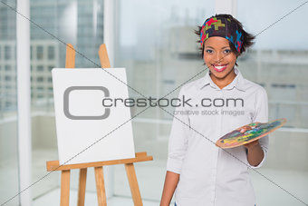Smiling artist holding palette