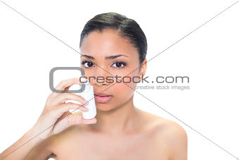 Charming young dark haired model using asthma inhaler