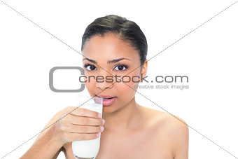 Charming young dark haired model drinking milk