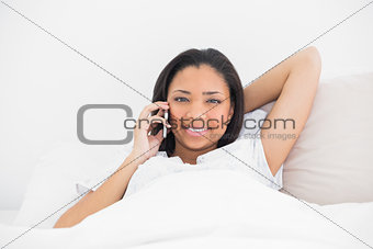 Relaxed young dark haired model making a phone call