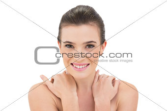 Cheerful woman crossing arms over shoulders