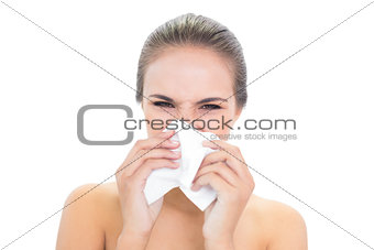 Young brunette woman using a tissue