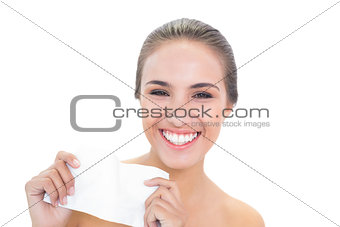 Smiling brunette woman holding a tissue