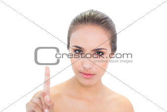 Young brunette woman holding up her finger