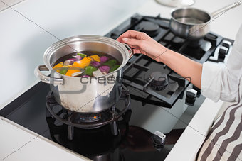 Close up on woman cooking healthy vegetables