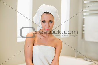 Stern natural brown haired woman preparing for her shower