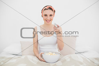 Smiling woman watching television