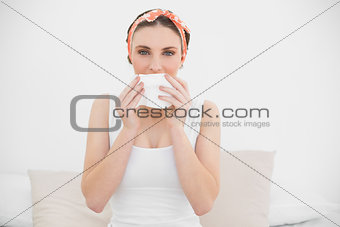 Woman smelling on a handkerchief looking into the camera