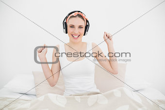 Pretty woman wearing headphones looking into the camera