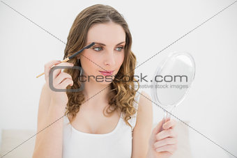 Pretty woman using an eyebrow pen