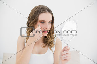 Woman plucking her eyebrows