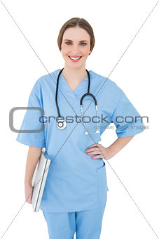 Young female doctor holding a notebook and smiling into the camera