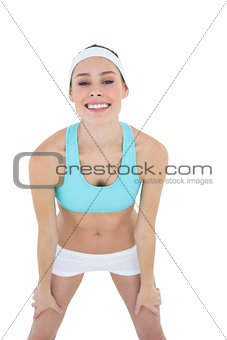 Beautiful happy woman posing wearing sportswear looking cheerfully at camera