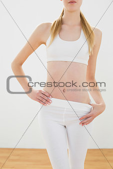 Slender young woman posing in sportwear