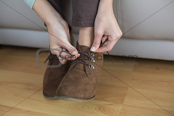 Slender woman tying her shoelaces