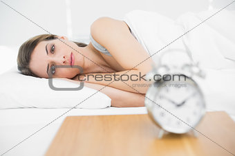 Calm attractive woman lying on her bed