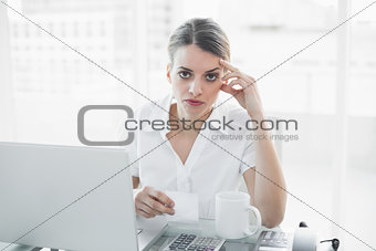Unhappy businesswoman working sitting at her desk