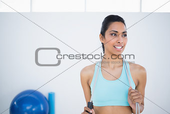 Pretty woman in sportswear holding a rope