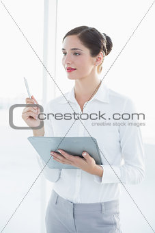 Young business woman with clipboard and pen
